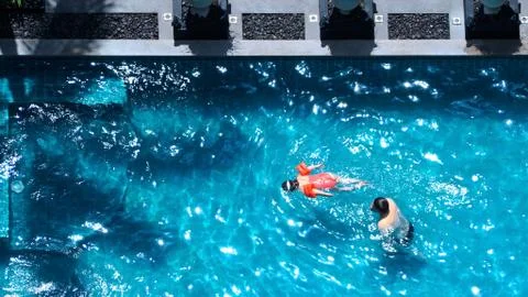 High angle view of swimming pool that father and daughter are playing togethe Stock Photos