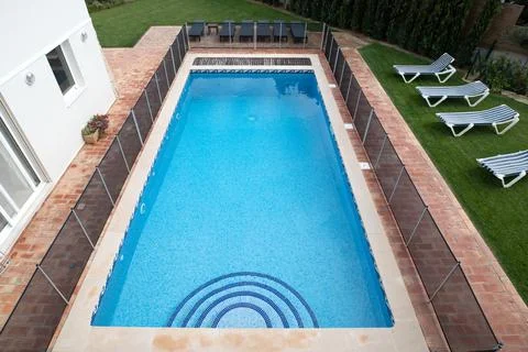 High angle view of a swimming pool with child safety fence around it Stock Photos