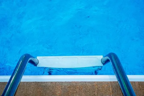High angle view of swimming pool ladder and clean inviting blue water Stock Photos