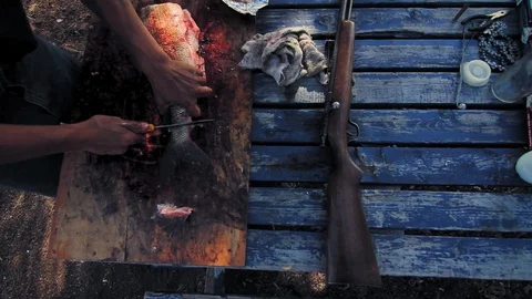 High angle view of table with fisherman cleaning a fish. Video stock 116804429