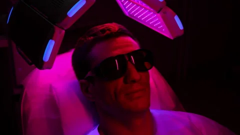 High-angle view of talking male in protective goggles having LED light hair Stock Footage 277908481