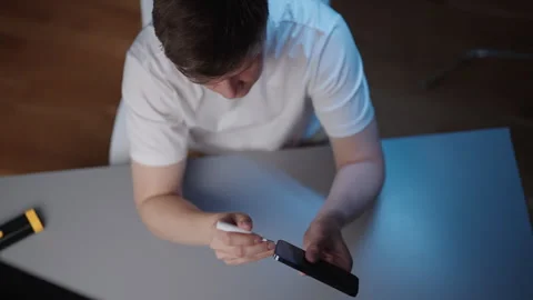 High-angle view of technician male using precision tool to clean dust and debris Stock Footage 320216659