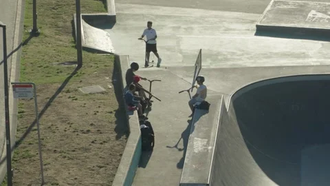 High angle view of teens riding scooters in Cimadevilla skatepark in Gijon Stock Footage 346341060