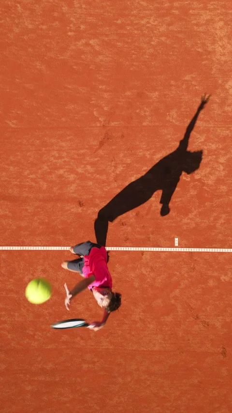 High-angle View of Tennis Player in Dynamic Play on Clay Court 스톡 동영상 317959336