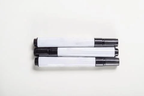 High-angle view of three black permanent markers with white barrels placed .. 写真素材