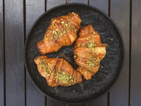 High angle view of three croissants with pistachios on top of them Stock Photos