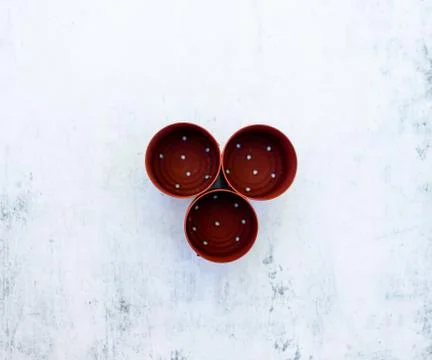 A high angle view of three small red cans with holes on the table under the l Stock Photos