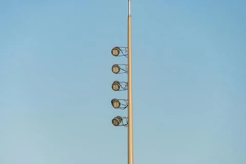 A high-angle view of three tall, cylindrical, black light posts with multip.. Stock Photos