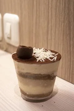 High angle view of Tiramisu cake topped with grated cheese, chocolate and cocoa Stock Photos