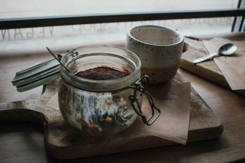 High angle view of tiramisu in glass cup with coffee cappuccino. In vegsn sho Stock Photos