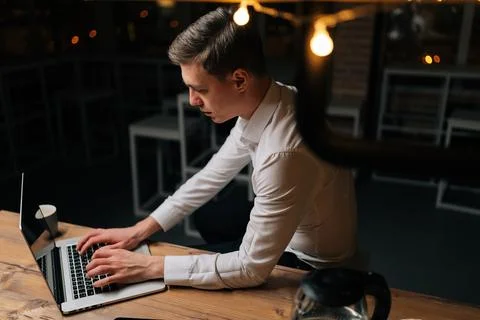 High-angle view of tired young businessman remote working overtime, learning Stock Photos
