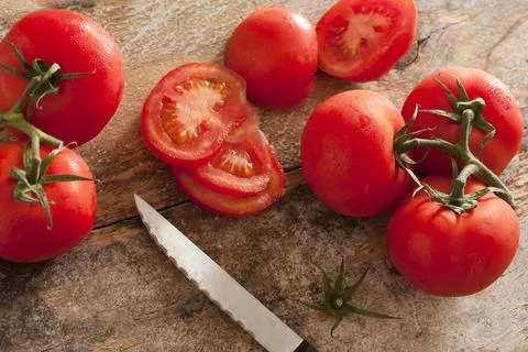 High-angle view of tomatoes on rustic wooden table Stock Photos