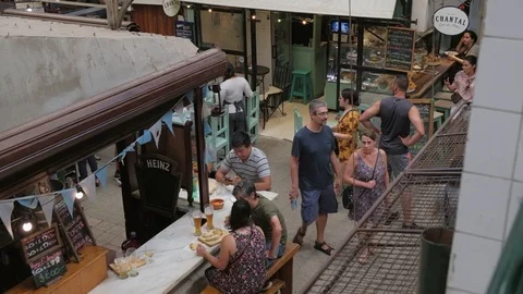 High angle view of tourists having lunch on a food stall in San Telmo Fair Stock Footage 122600562