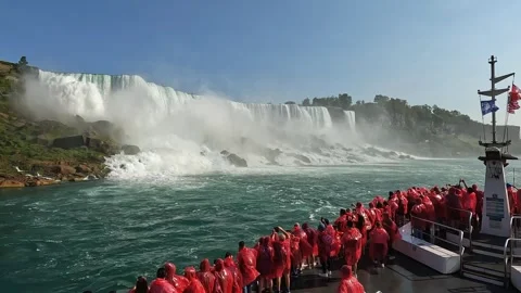 High angle view of tourists in red raincoats on boat viewing niagara falls Stock Footage 302578727