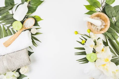 High angle view towels salt candles flowers leaves whit surface. High quality Stock Photos