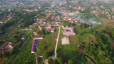 High angle view of a town with buildings, roads, and green spaces Stock Footage 321653719