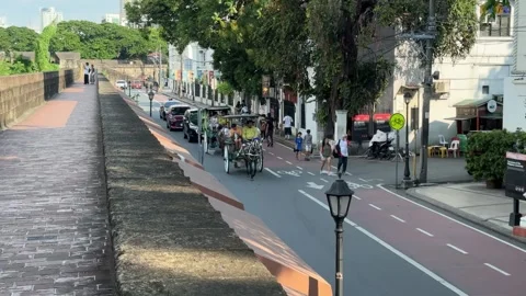 High angle view of a traditional kalesa followed by cars in Intramuros 4K Stock Footage 337457841