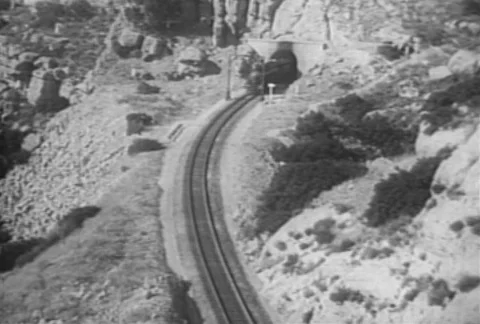 High angle view of train coming through mountain tunnel, 1930s 스톡 동영상 95997507