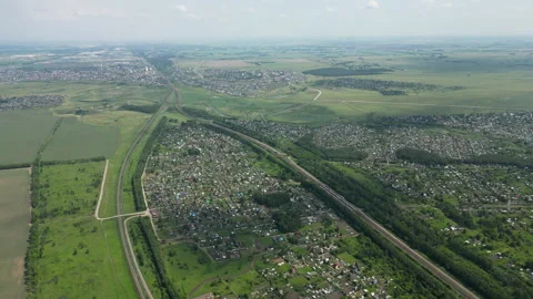 High angle view of a train moving through the countryside near a small town Stock Footage 316227313