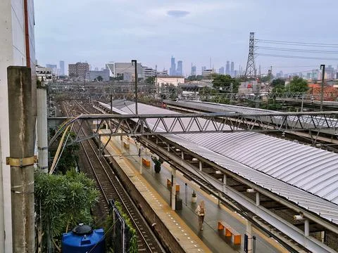 High angle view of a train station platform and city skyline in the background Stock Photos