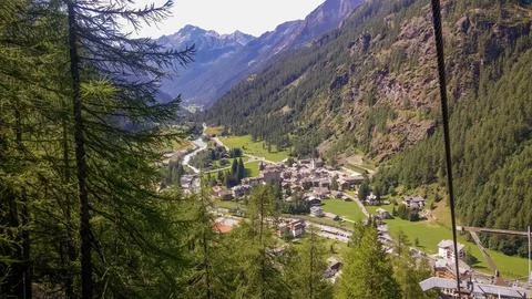 High angle view of trees and houses against mountains from cable way gressoney Stock Photos