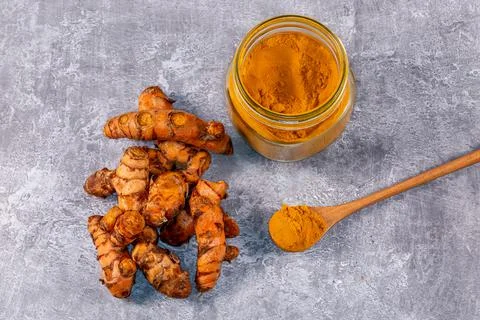 A high angle view of turmeric root and powder Stock Photos