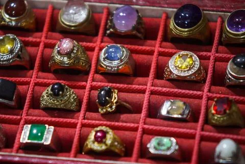 High angle view of turquoise and green gemstone rings in collection tray Stock Photos