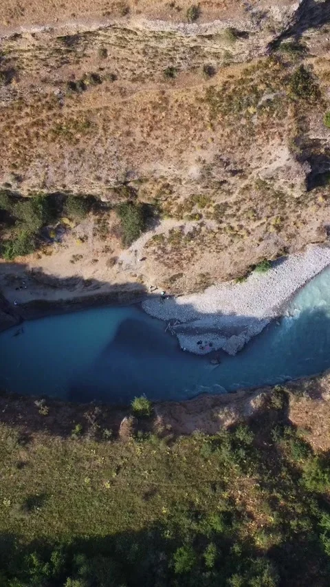 High angle view of turquoise river entering narrow deep gorge in rocky canyon Stock Footage 336690464
