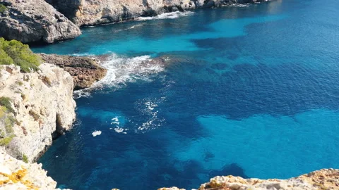 A high angle view of the turquoise sea and the rocky coastline. Stock Footage 91252637