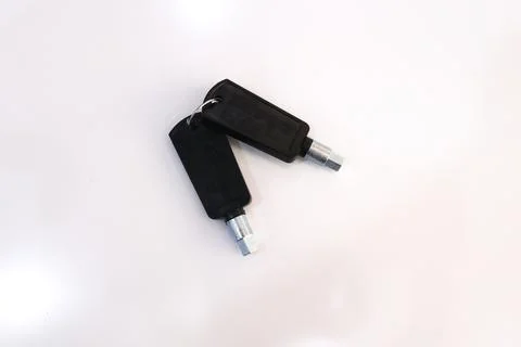 High angle view of two black plastic head keys attached to a key ring Stock Photos