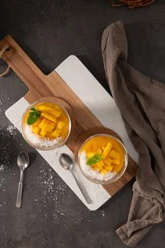 High Angle View of Two Glass Bowls of Mango Pudding with Coconut and Mint Stock Photos