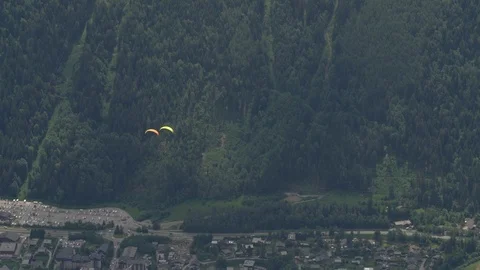 High angle view of two paragliders over a valley in Chamonix, France Stock Footage 124397236
