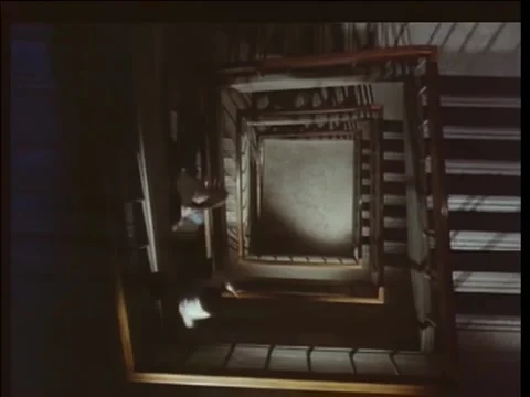 High angle view of  two people walking down spiral staircase, 1970s Stock Footage 260257738