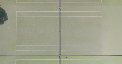 High-angle view of two tennis courts. ST HELIERS, AUCKLAND, NEW ZEALAND Stock Footage 303213008