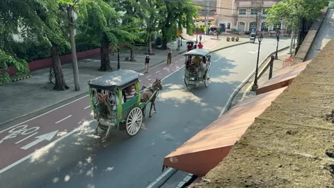 High angle view of two traditional kalesas driving in Intramuros 4K Stock Footage 337457743