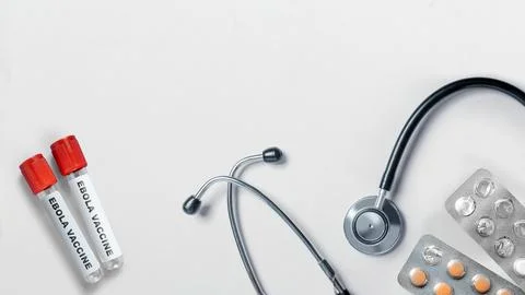 High-angle view of two vials labeled Ebola Vaccine, a stethoscope, and blis.. Stock Photos