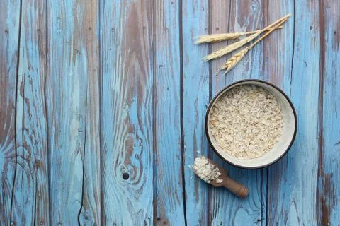 High angle view of uncooked oats flakes in a bowl on table Stock Photos