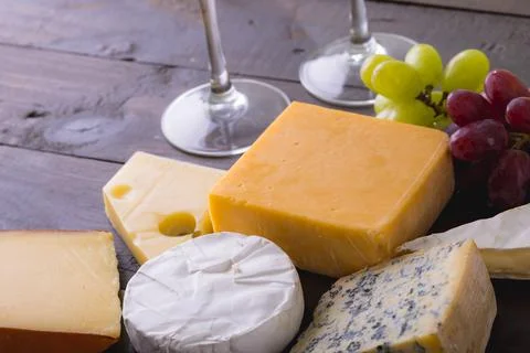 High angle view of various cheese with grapes on table, copy space Stock Photos