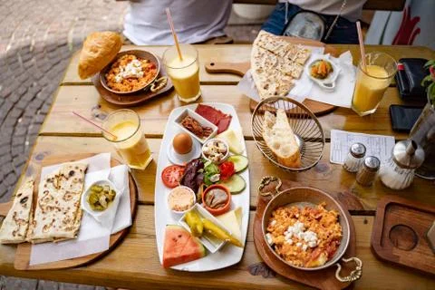 High angle view of various food and drink served on wooden table at sidewalk Stock Photos