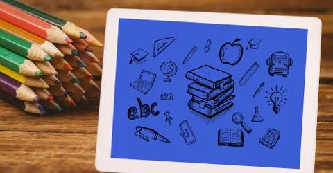 High angle view of various icons in digital tablet by color pencils at table Stock Photos
