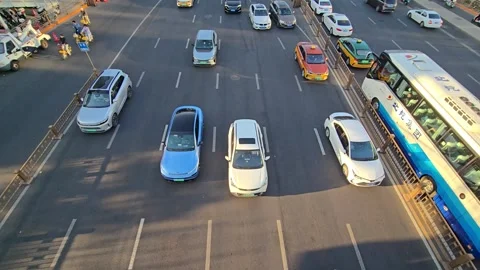 High angle view of various vehicles including a large tour bus, cars, and cyc Stock Footage 331594977