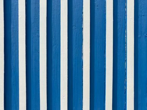 A high-angle view of vertical wooden planks painted in alternating, crisp s.. Stock Photos