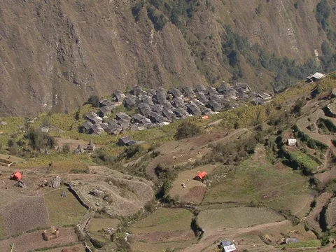 High angle view of village huts in valley, with terrace farms on mountain slope Stock Footage 86748875