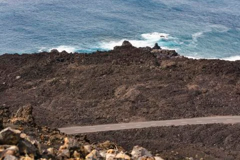 High angle view of volcanic lava coastline with a road in the south of La Pal Stock Photos