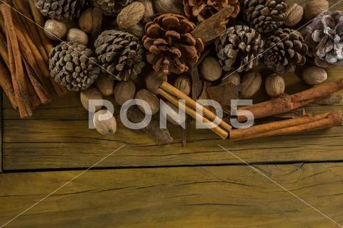 High angle view of walnuts with pine cones and cinnamon stick Stock Photos