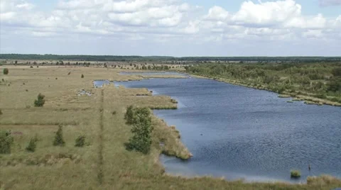 High angle view from watchtower at raised bog landscape + pan peat lake Stock Footage 41309233