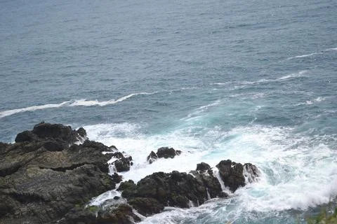 High angle view of waves splashing on rocks Stock Photos