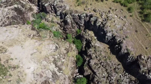 High angle view of weathered basalt cliffs and dry gorge topography, Kazakhstan Stock Footage 337914521