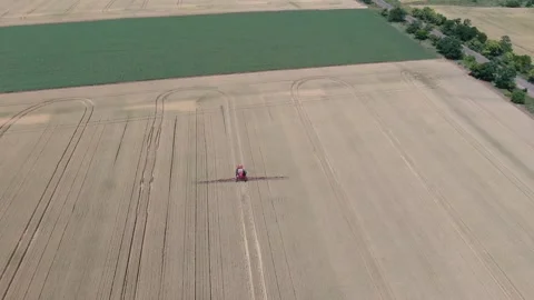 High angle view on a wheat field and a sprayer watering the plants Stock Footage 138138744