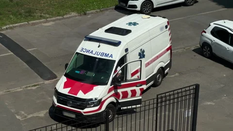 High-Angle View: White Ambulance Van Parked on Hospital Street with Driver Door Stock Footage 340048207